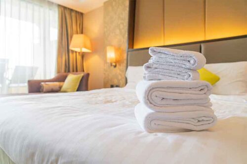 best bath towels laying on hotel bed