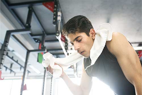 man working out using gym towel